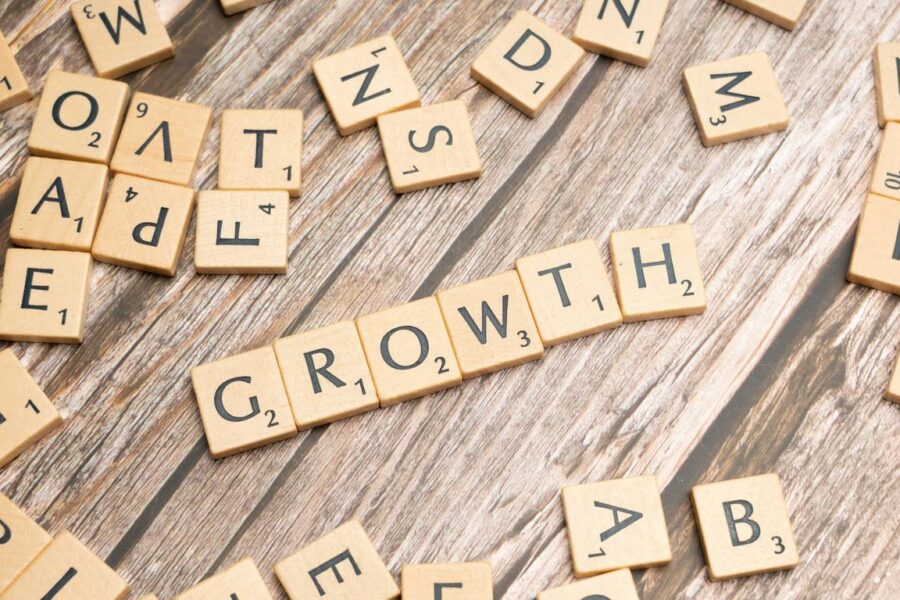 scrabbled letters spelling growth on a wooden surface