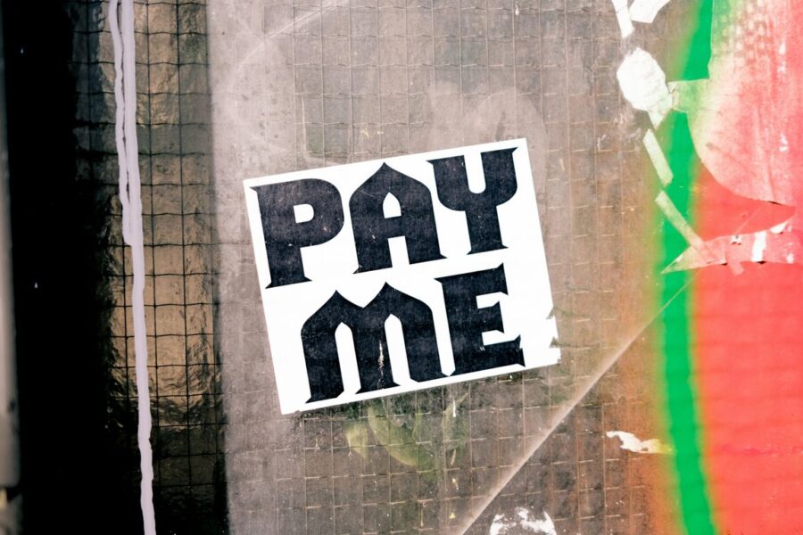 a pay me sticker on the side of a building