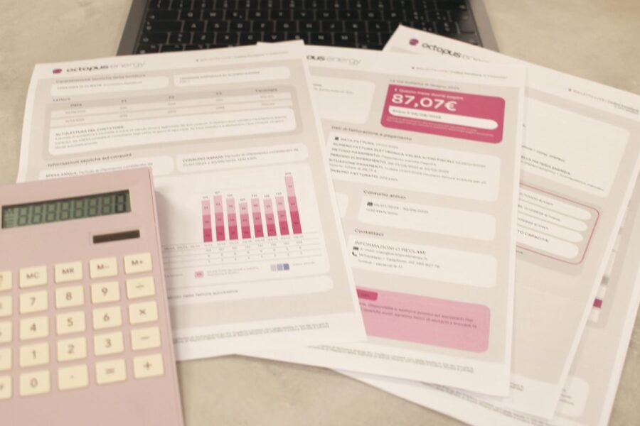 Bills, calculator, and a laptop: financial tasks underway.