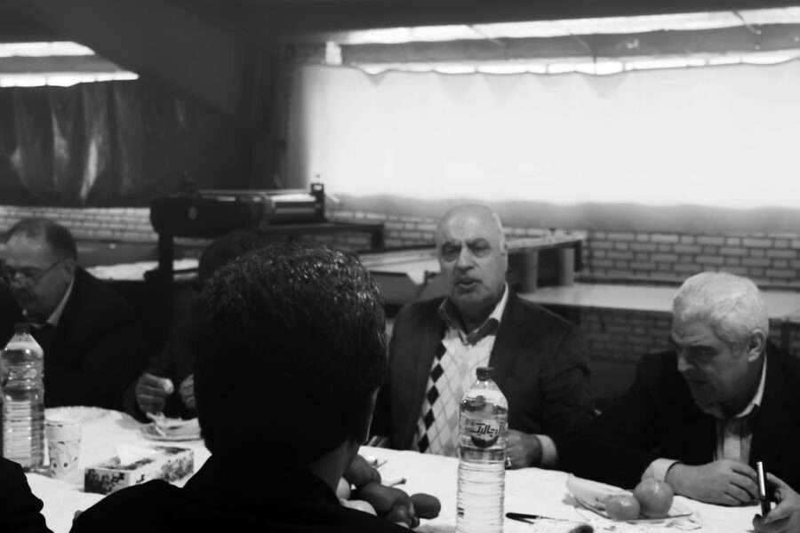 grayscale photo of men eating